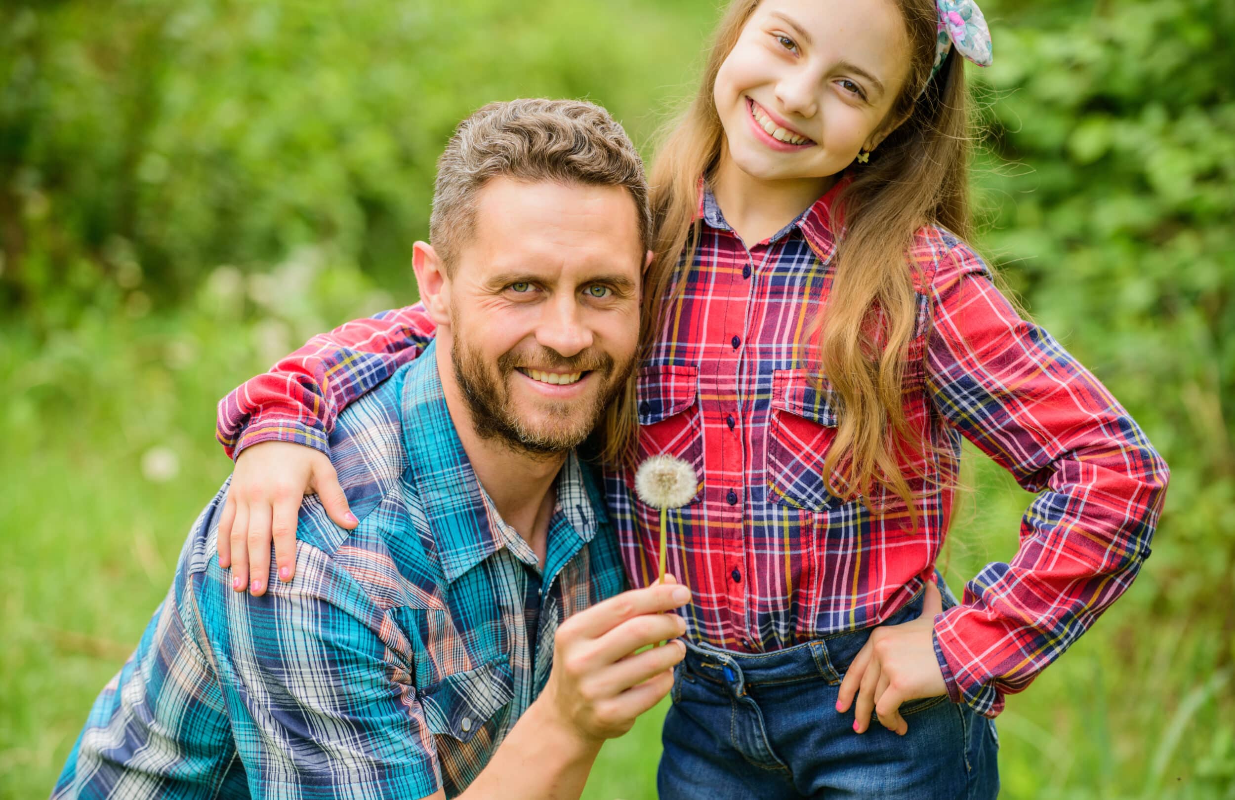 Dad and daughter blowing dandelion seeds. Keep allergies from ruining your life. Seasonal allergies concept. Outgrow allergies. Biggest pollen allergy questions. Father little girl enjoy summertime