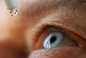 Man drops eye drops install lenses, moisturizing