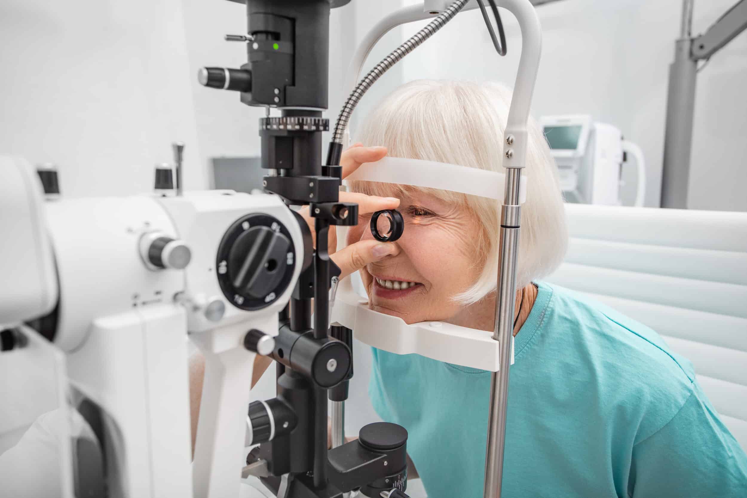 Elderly woman eyesight test with binocular slit lamp. Checking retina of a female eye close up. Ophthalmology Clinic