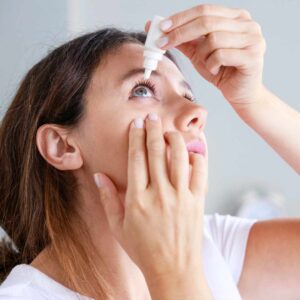 woman using eye drops