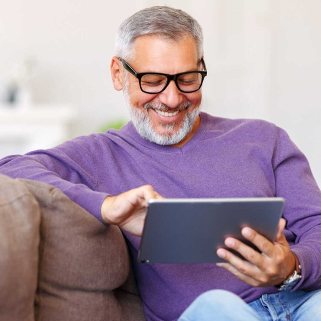 TCSC banner clouding man with glasses reading tablet